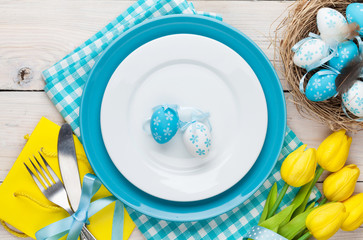 Easter with yellow tulips and colorful eggs