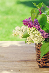 Colorful lilac flowers in basket