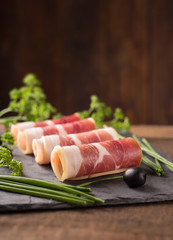 Delicious sliced bacon on wooden table