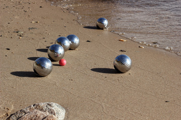 Petanque balls on the sandy beach