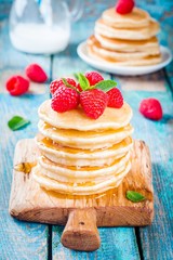 Homemade pancakes with honey and raspberry
