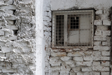 The wall of the old house from the brick and plaster painted in