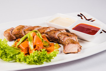 Meet sauce and vegetables on white plate
