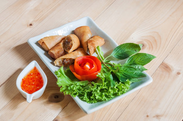 Fried Chinese Traditional Spring rolls food isolated on wood bac
