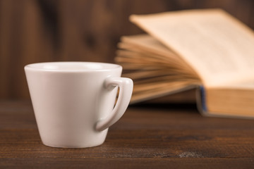cup of coffee with book in coffee shop