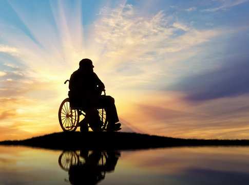 Silhouette of disabled person in a wheelchai