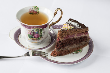 Piece of cake with chocolate and tea