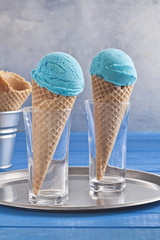 Blue ice cream cones on the blue table.
