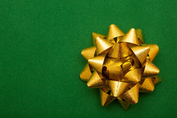 Gold bow on green background