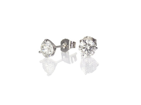 Diamond stud fine jewelry round brilliant pierced earrings isolated on white with a reflection