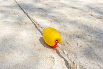 Fototapeta na wymiar Yellow buoy on the beach
