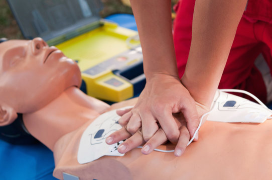 Hands of a paramedic doing chest compression during defibrillator CPR training