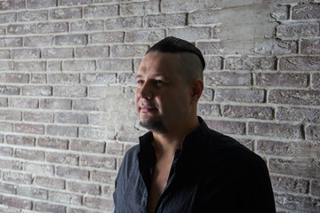 Obraz premium Portrait of a young man, dressed in black shirt, fashionable hai