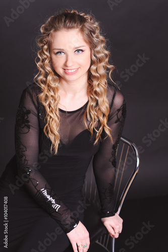 Smiling Blonde Woman 20 25 Year Old Sitting On Chair In
