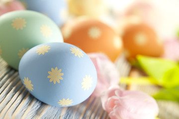 Easter eggs in pastel colors and spring flowers