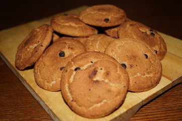 Sweet cookies with chocolate on the wooden table