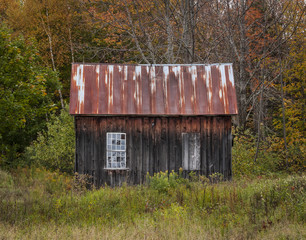 Old Wooden Shack: An abandoned wooden shack with two windows, one closed up near Peacham, Vermont - 104017676