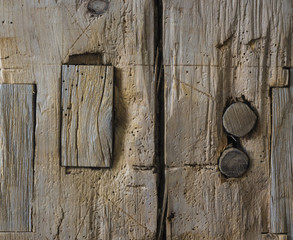 Timber Frame Barn Post: A detail of an old timber frame barn post with the pegs and part of the sawed off tenon showing, along with the carpenters scribe marks - obrazy, fototapety, plakaty