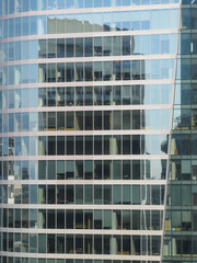 Glasfassade an einem Bürogebäude in Vancouver, Kanada, in der sich ein anderes Gebäude spiegelt