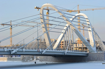 Fototapeta na wymiar Сonstruction cranes and Lazarevsky bridge
