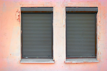 Two windows covered with blinds