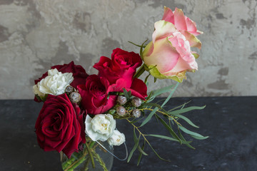 A bouquet of flowers of roses, carnations and other flowers.