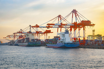 Cargo freight ship with stacked container at harbor terminal