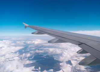 Wing of aircraft over the cloud field. Copyspace.