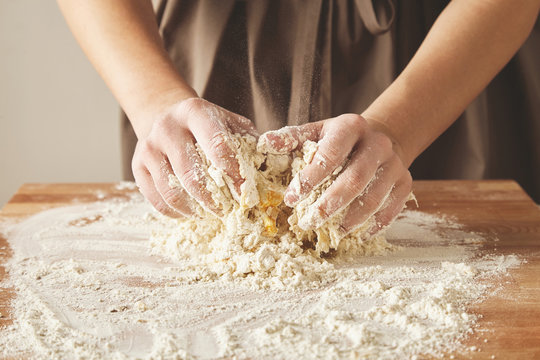 Woman hands knead dough for pasta