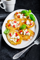 Potato pancakes with goat's curd, chili peppers and basil