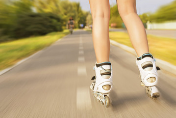Beautiful girl with roller blade in park, motion blur effect. Outdoor, recreation, lifestyle,...