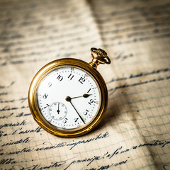 Golden Pocket Watch on Ancient Paper, Retro Mood