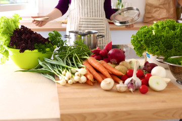 Young Woman Cooking in the kitchen. Healthy Food
