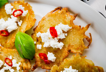 Potato pancakes with goat's curd, chili peppers and basil