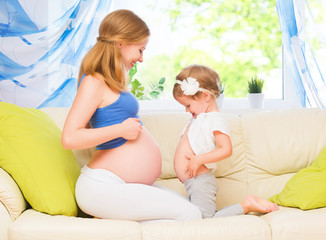 happy family. Pregnant mother and baby daughter having fun relax