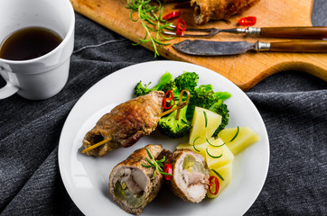 Pork rolls with cucumber and onion on plate