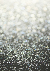 Unfocused abstract glitter holiday bokeh. silver golden lights. celebration card background.