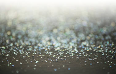 Unfocused abstract glitter holiday bokeh. silver golden lights. celebration card background.