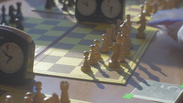 Kid's Hands Put a Black Chess to Files Game Clock is on a Table Kids Are Playing Chess at Chess Competition For Preschool Children in Opole Poland