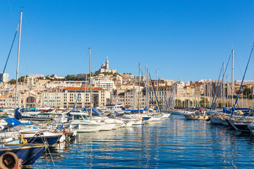 Marseille. View of Old Port. In the background, the Basilica of Notre-Dame de la Garde - obrazy, fototapety, plakaty