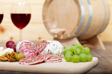 Still life with red wine and wooden cask.