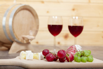 Still life with red wine and wooden cask.