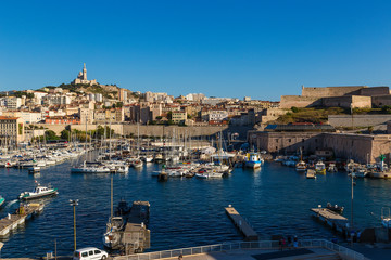 Fototapeta na wymiar Marseille. Old Harbour, Fort St. Nicholas and the Basilica Notre-Dame de la Garde