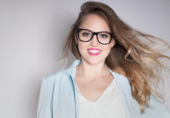 Young attractive laughing blonde smart happy business woman wearing glasses expressive portrait...