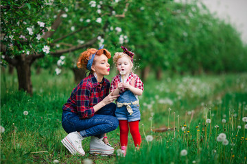 Fototapeta premium baby girl woman spring gardens and woman, dandelions
