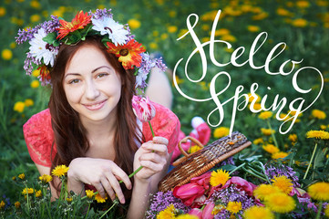young woman enjoying smell in a flowering spring garden with letters Hello sprint