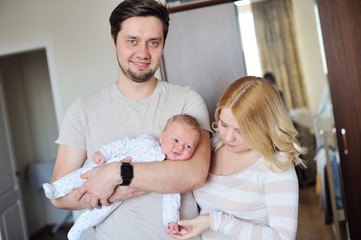 Happy Young Attractive Family parents with Newborn Baby