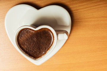 Coffee in heart shaped cup mug. Caffeine energy.