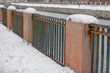 Snow on embankment fence