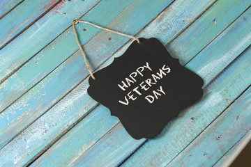 veterans day chalk sign on blue wood background